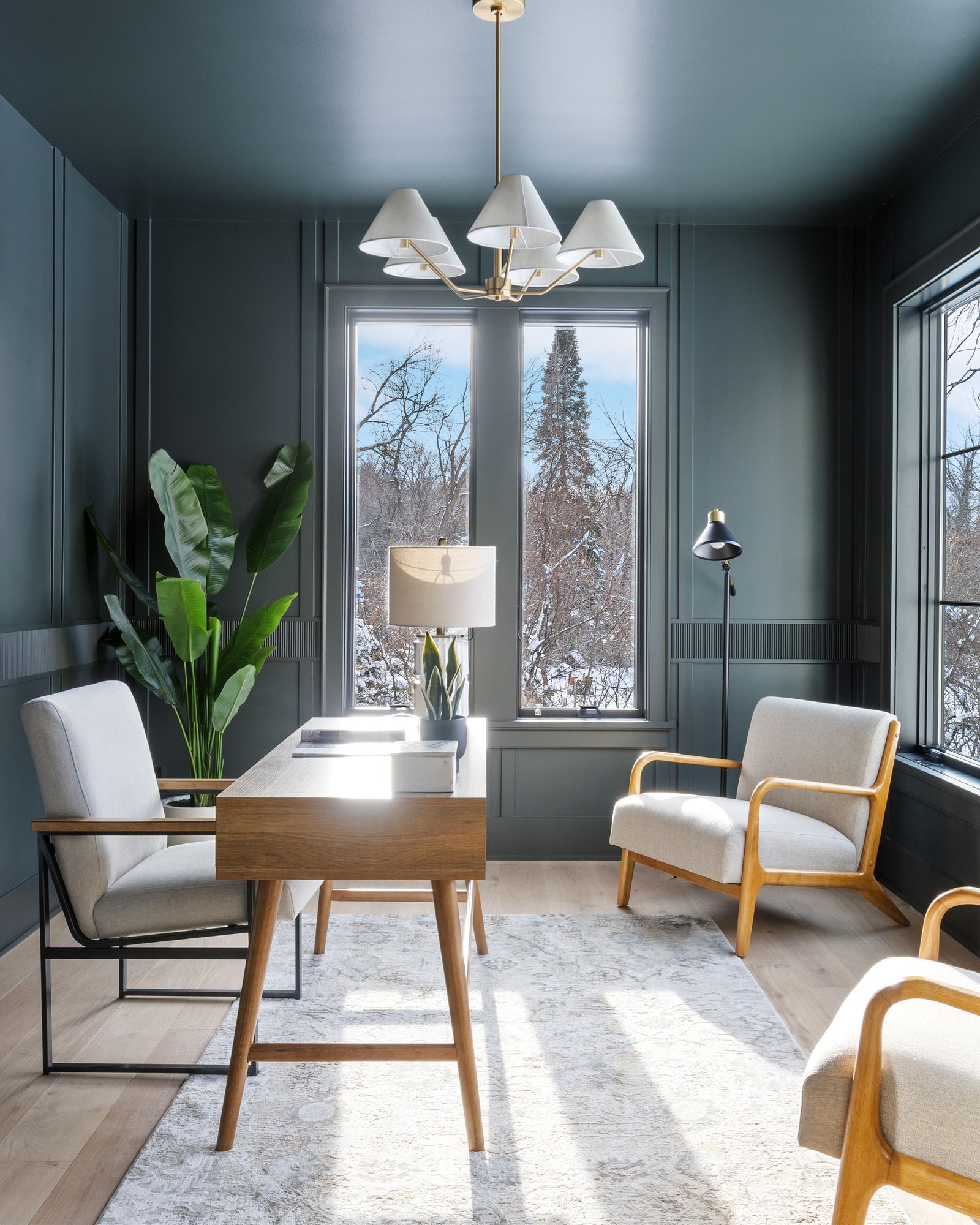 Office in the Dodd Road spec home, with deep green paneled walls, a brass chandelier, and tall windows