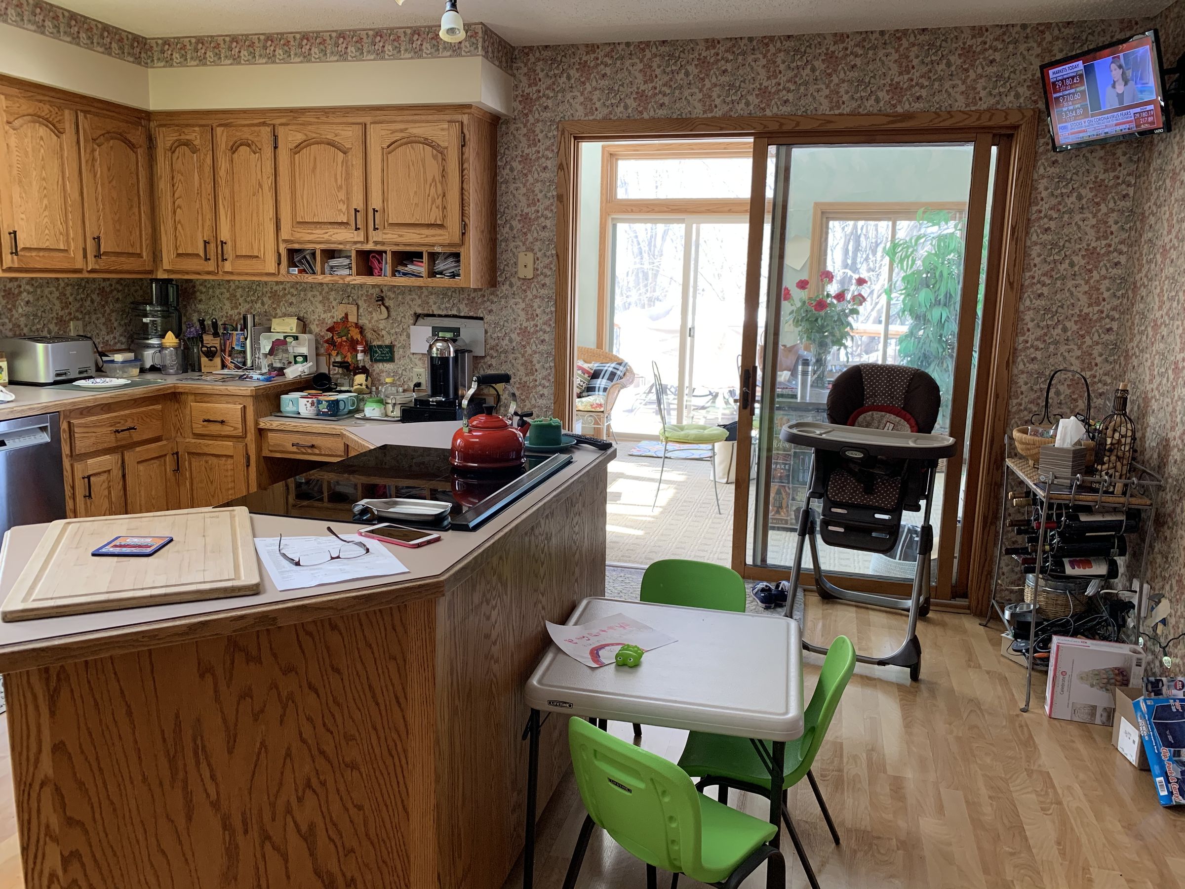 Before, the eat-in kitchen had an angled oak peninsula, laminate counters, and floral wallpaper on every wall