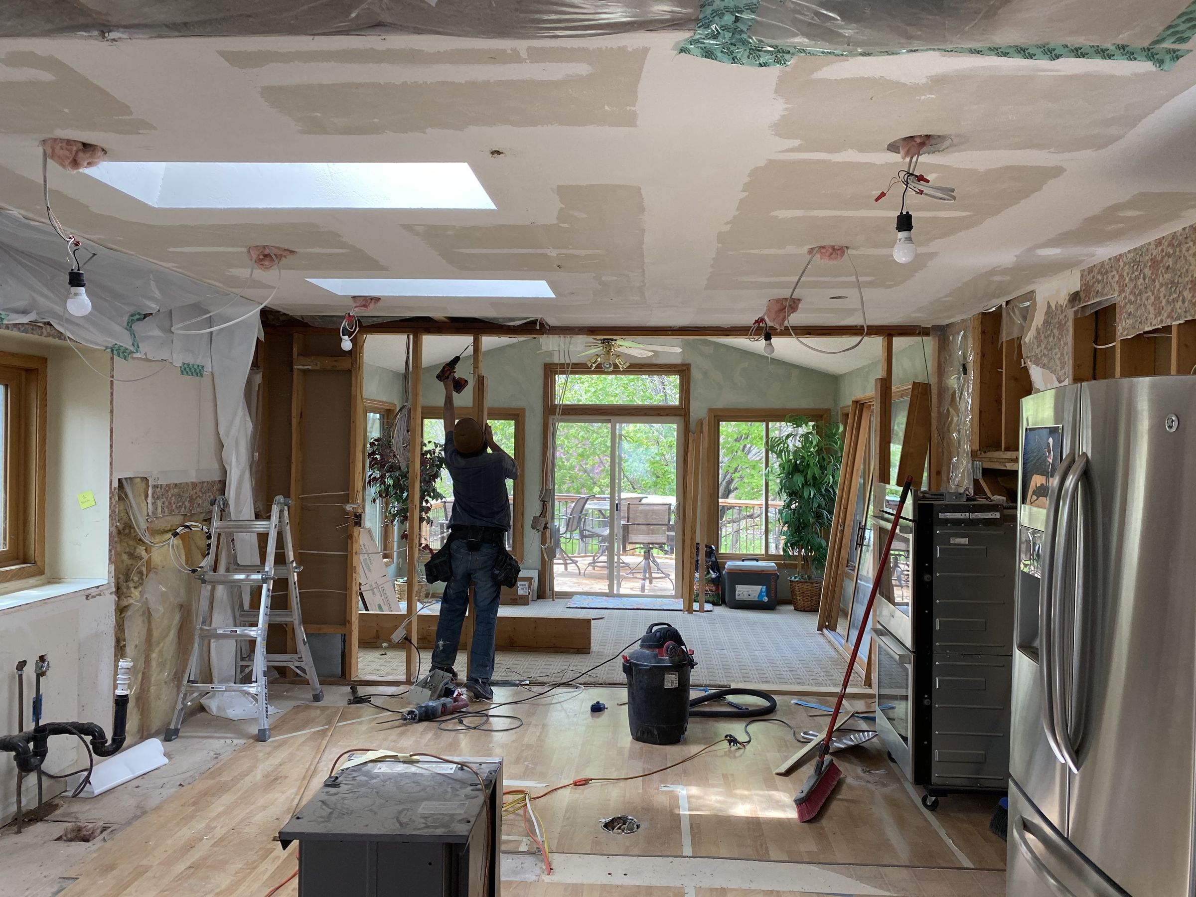 The kitchen gutted, with new lighting rough-in in the ceiling and the wall to the sunroom being reframed