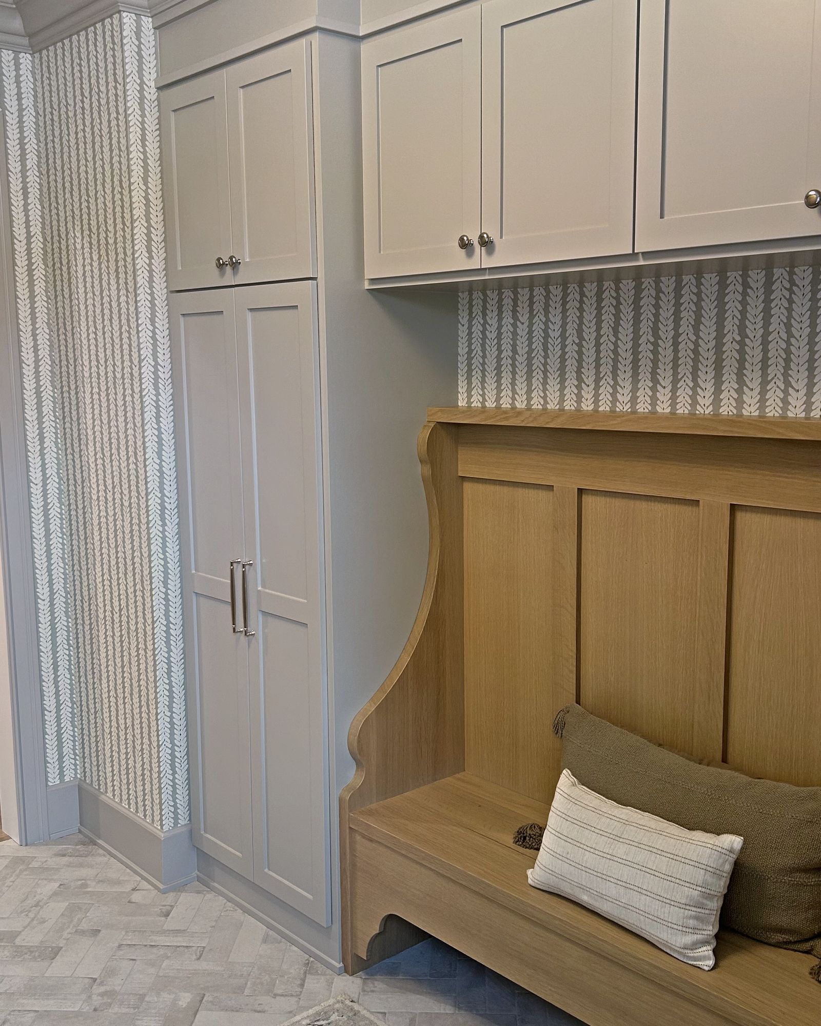 Custom mudroom cabinetry and a white oak built-in bench in a new build